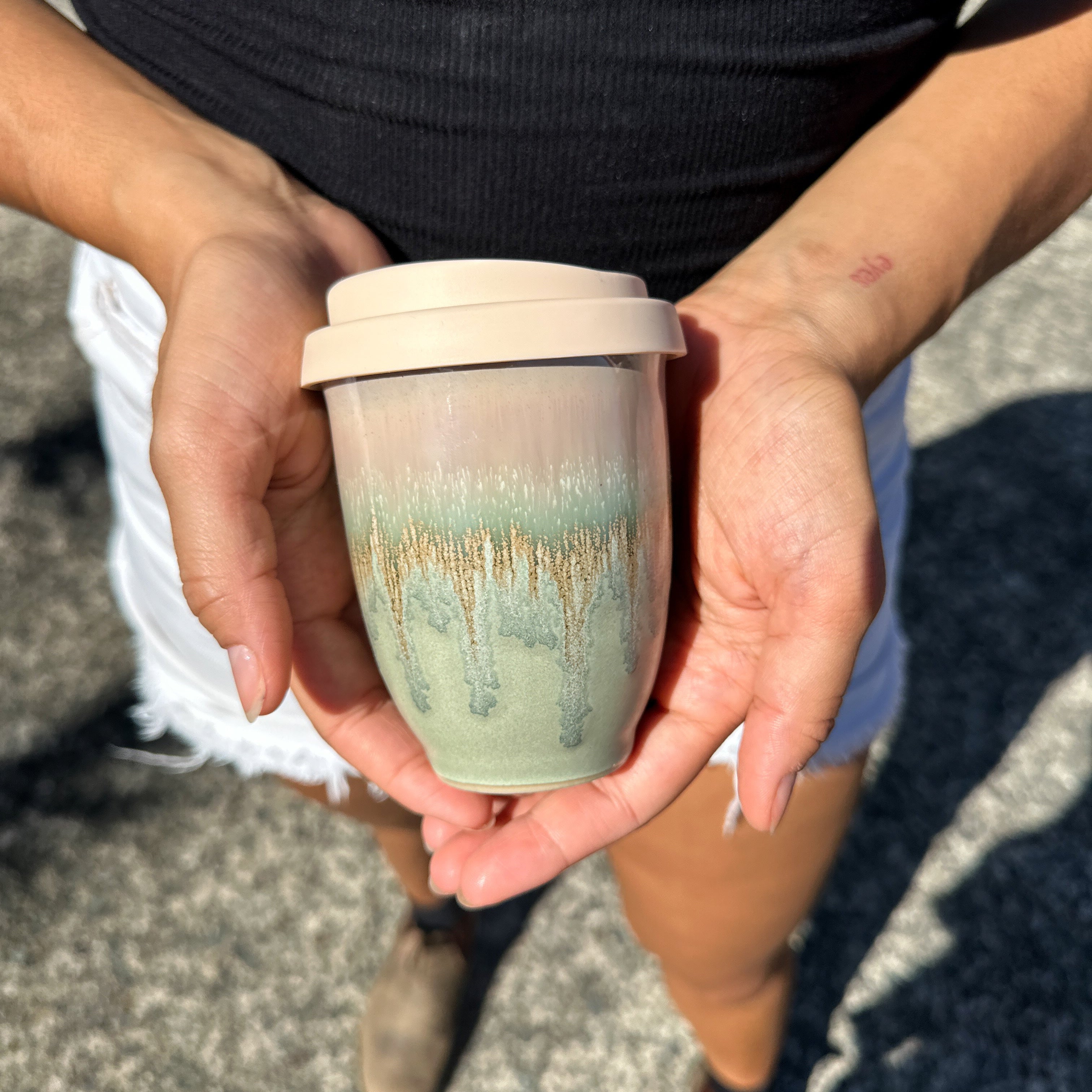 Pottery For The Planet Rainforest Jasper Travel Cup in hand