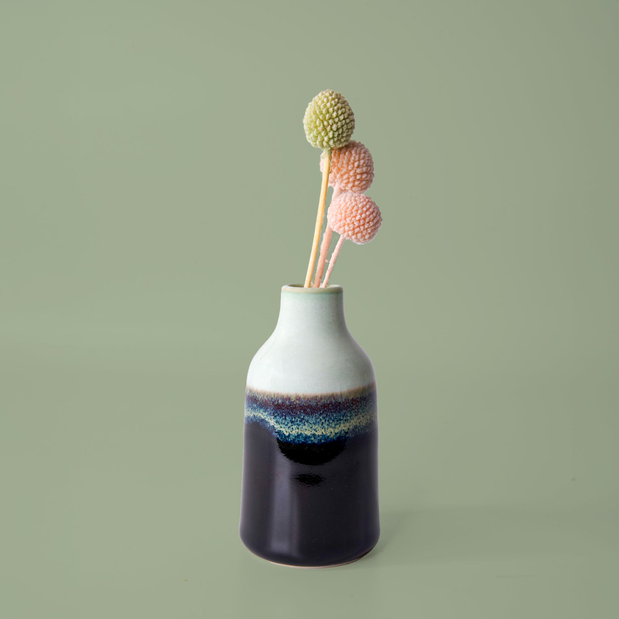 Pottery For The Planet modern decorative flower vase with gradient blue and white finish holding dried flowers