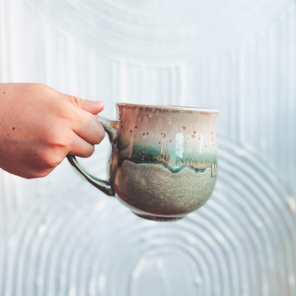 Green Mug in Hand white background