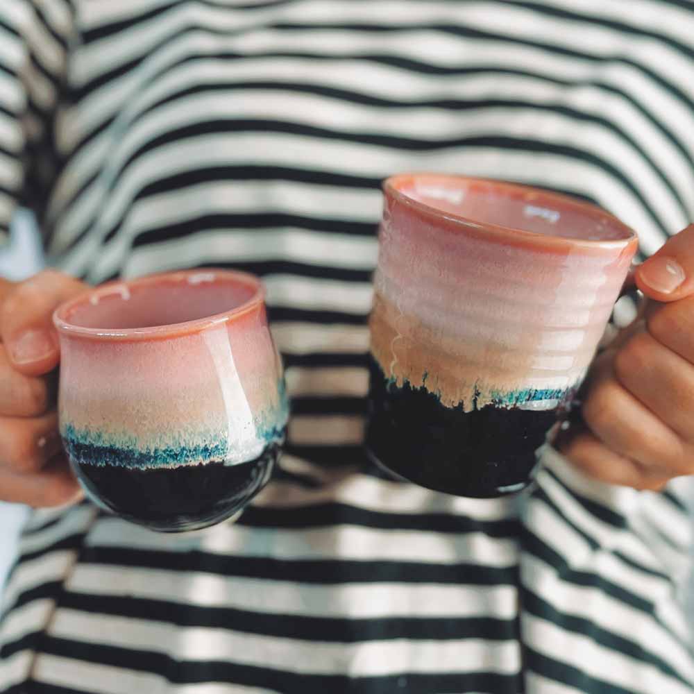 Purple and Black Mug in Hand