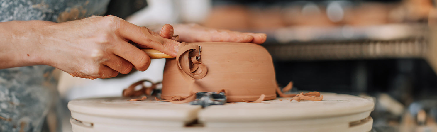 Bowl On Pottery Wheel Being Carved