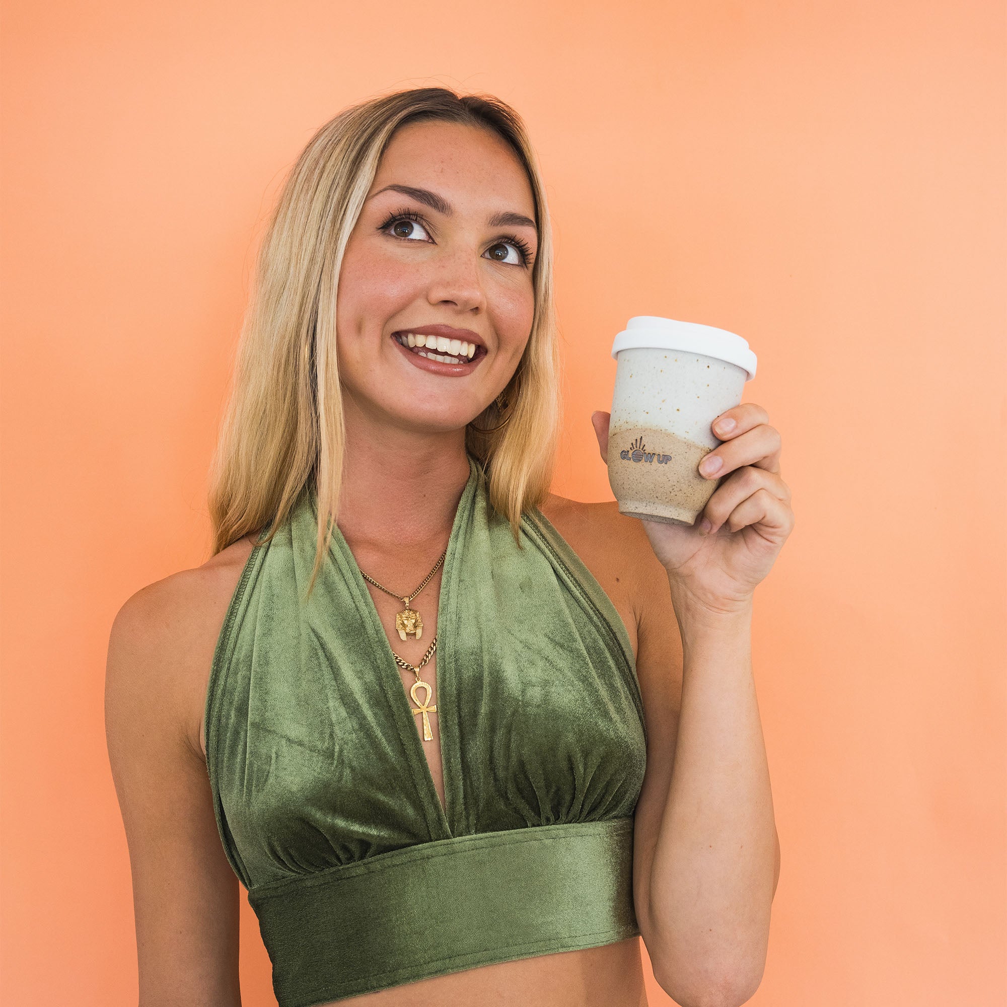 Moodshot holding the sandy glow up cup