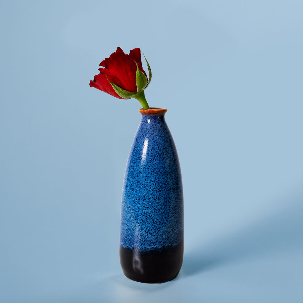 Pottery For The Planet artisan decorative vase for flowers in blue and black holding a single red rose