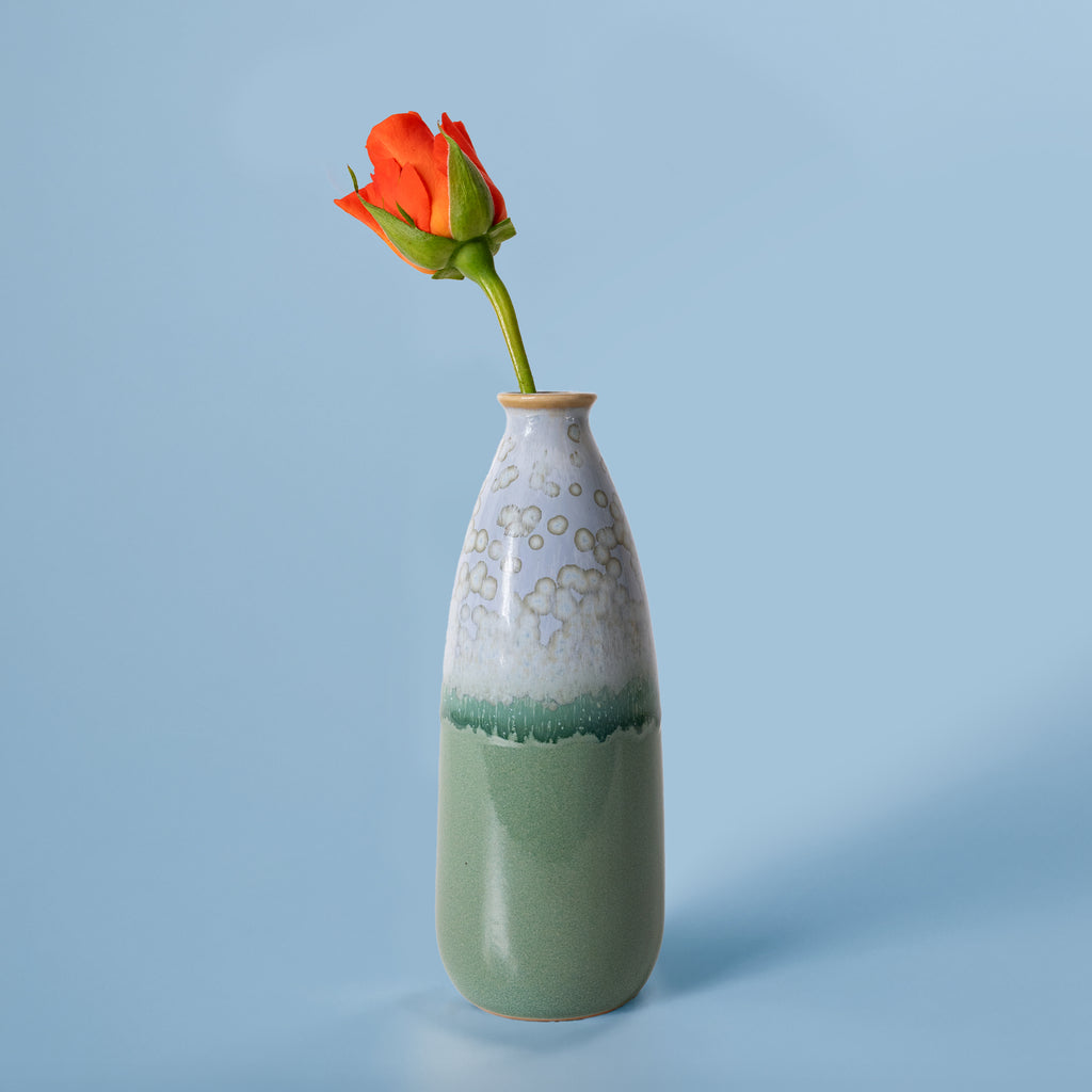 Pottery For The Planet artisan decorative vase for flowers in green and white with a single orange rose