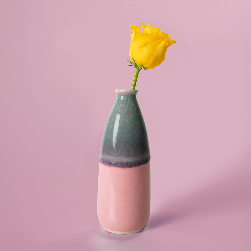 Artisan decorative vase for flowers by Pottery For The Planet with green and pink glaze holding a yellow rose