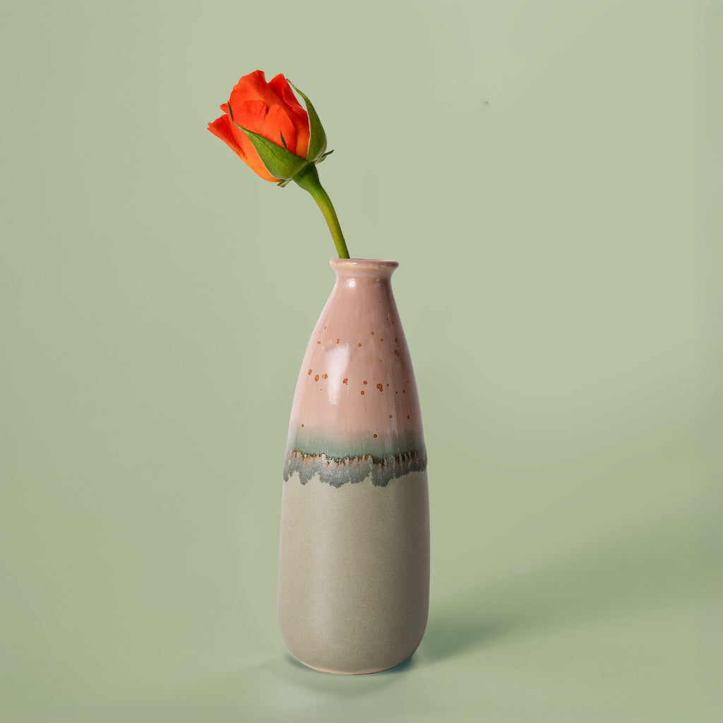 Pottery For The Planet artisan decorative vase for flowers in pink and gray holding an orange rose