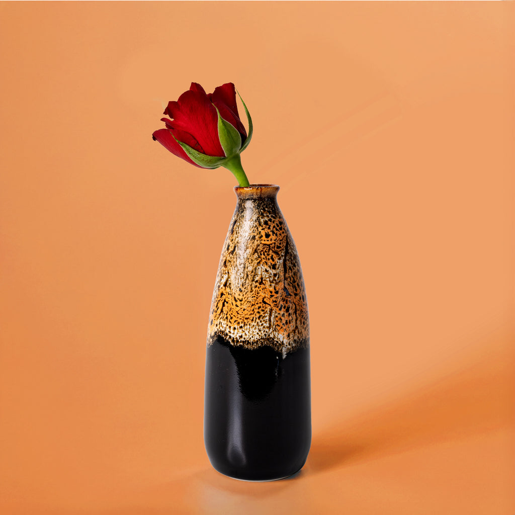 Pottery For The Planet artisan decorative vase for flowers with black and brown glaze holding a red rose