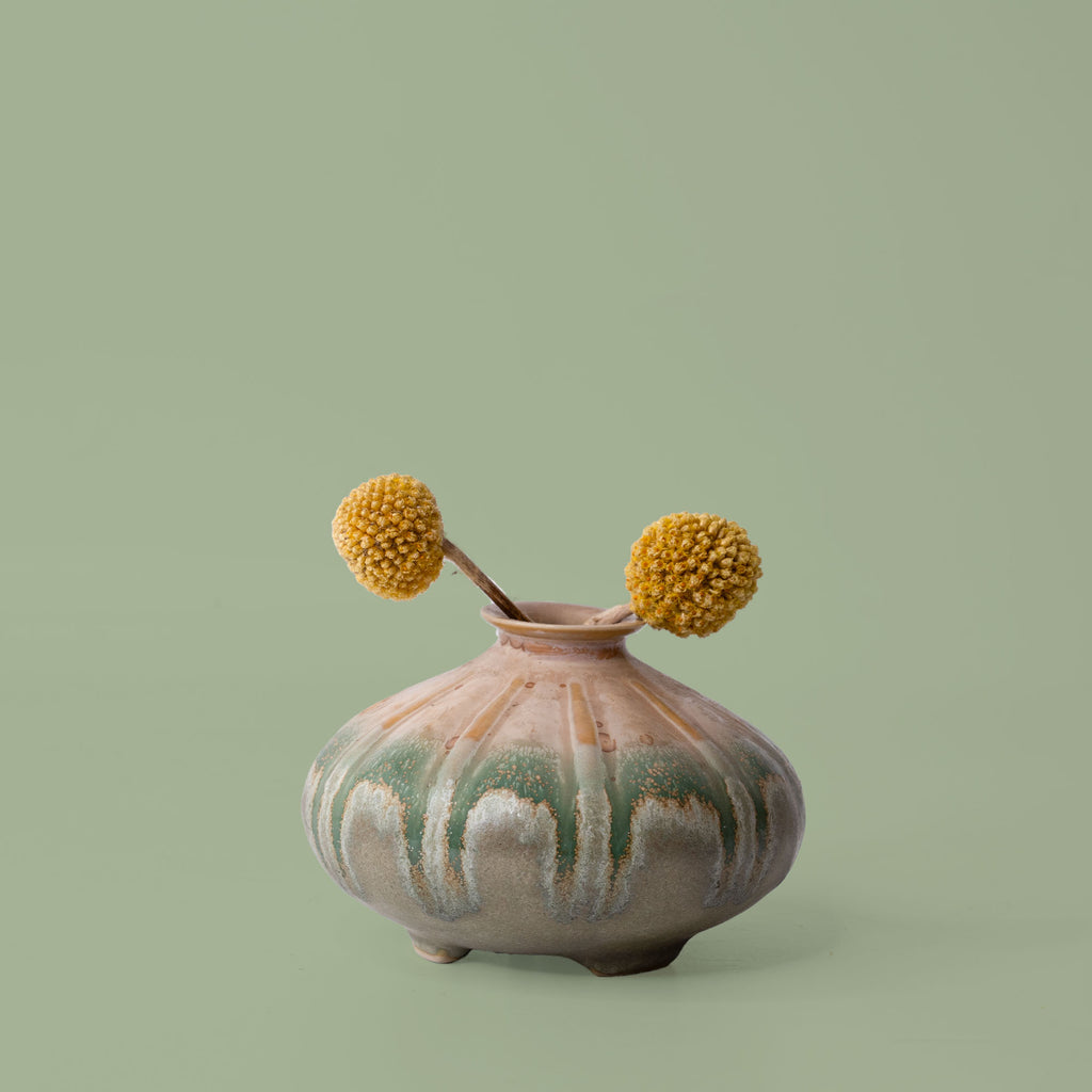 Pottery For The Planet artisan decorative vases in green and beige with a rounded shape and dried yellow flowers