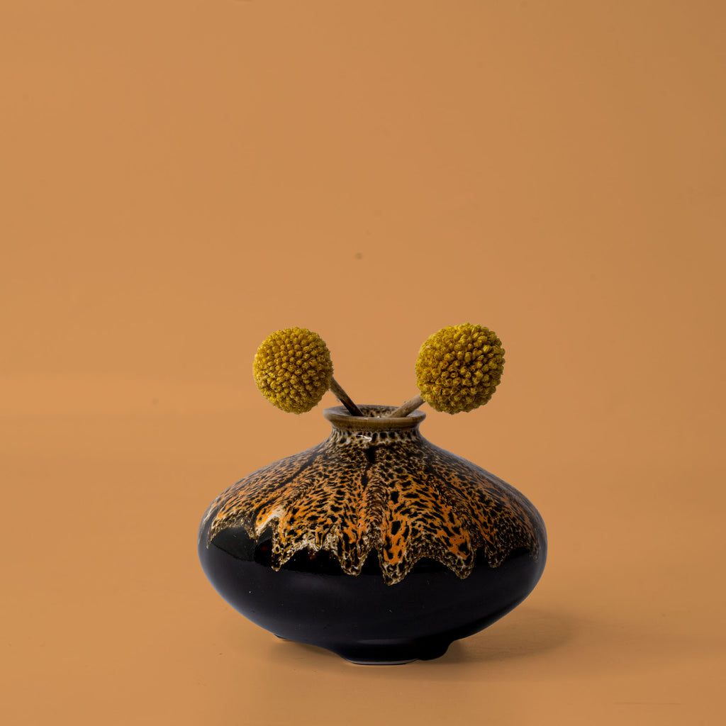 Pottery For The Planet artisan decorative vases with dark glossy finish and yellow floral accents