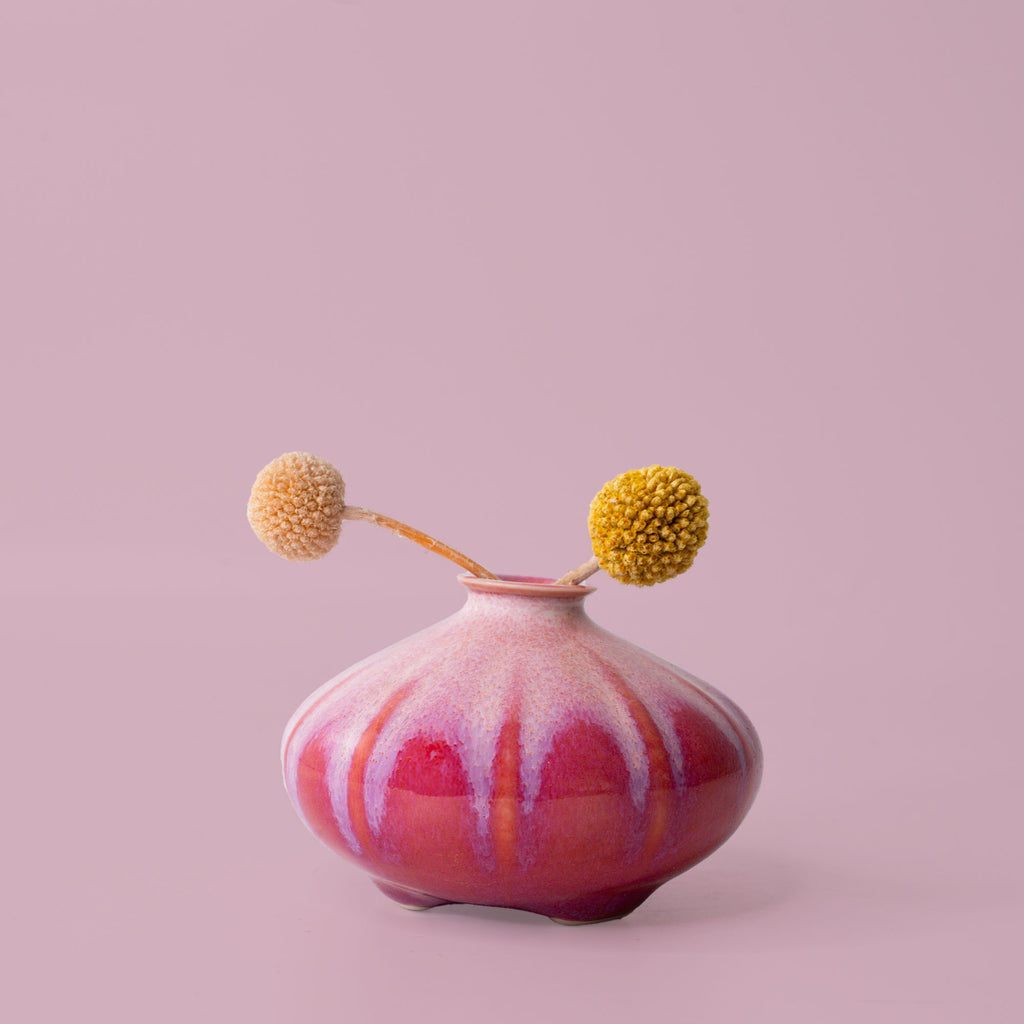 Pottery For The Planet pink and red artisan decorative vase with a unique rounded shape holding two dried flowers