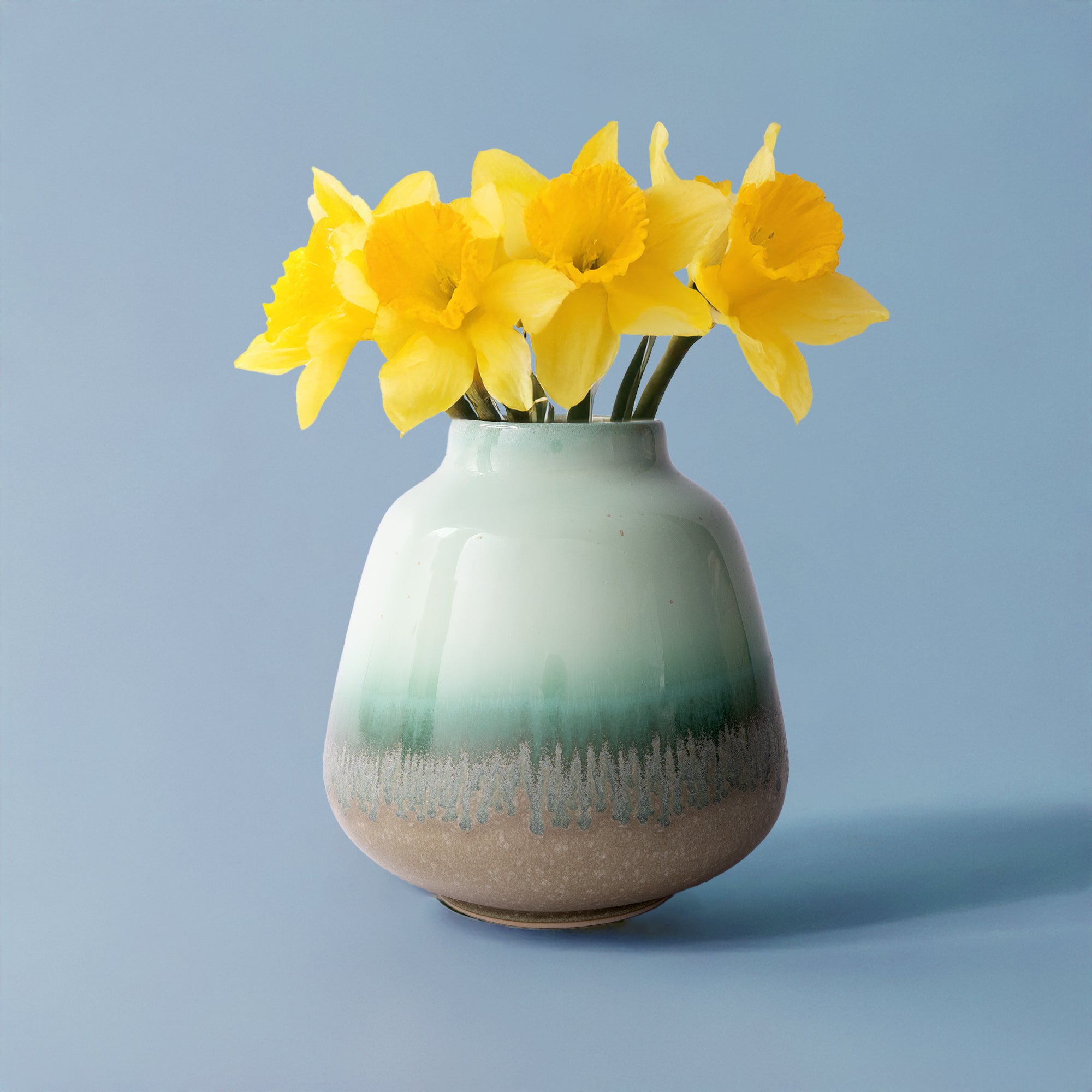 Pottery For The Planet ceramic bouquet vase for home decor with green and beige glaze holding yellow flowers