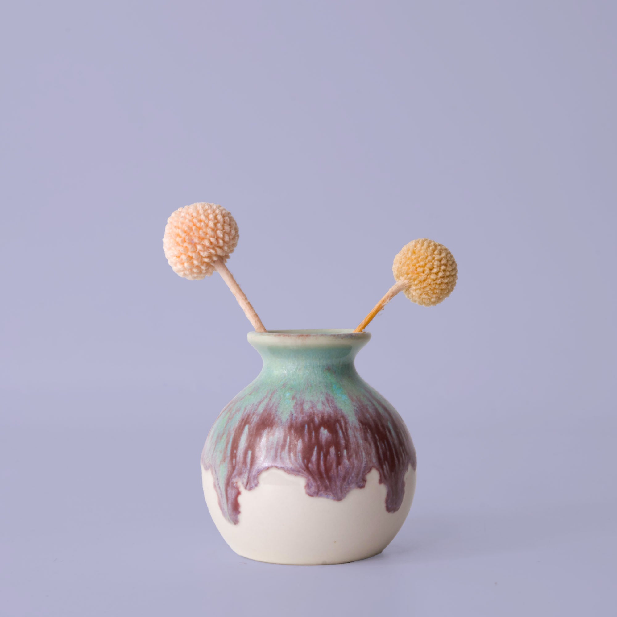 Pottery For The Planet eco-friendly home decor vase with green and brown glaze holding dried flowers