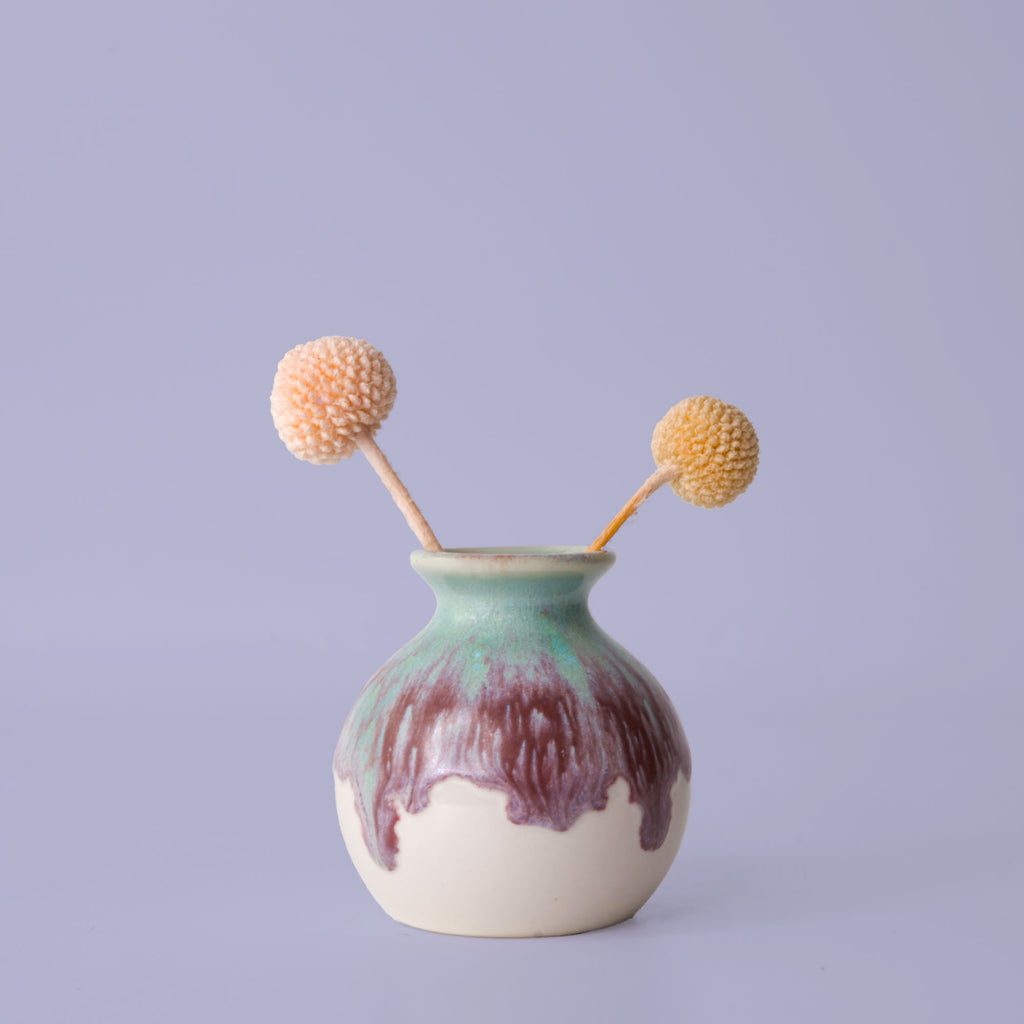 Pottery For The Planet eco-friendly home decor vase with green and brown glaze holding dried flowers