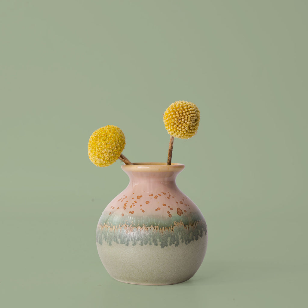 Pottery For The Planet eco-friendly home decor vase with pink and green glaze holding yellow billy ball flowers