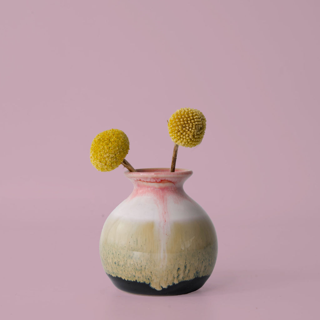 Eco-friendly home decor vase by Pottery For The Planet with a rounded shape and pink, beige, and black glaze