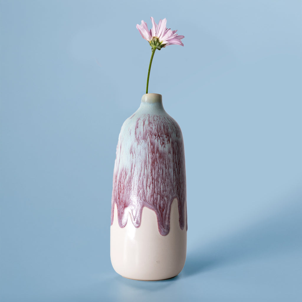 Pottery For The Planet eco-friendly home decor vase in white and purple with a single pink flower