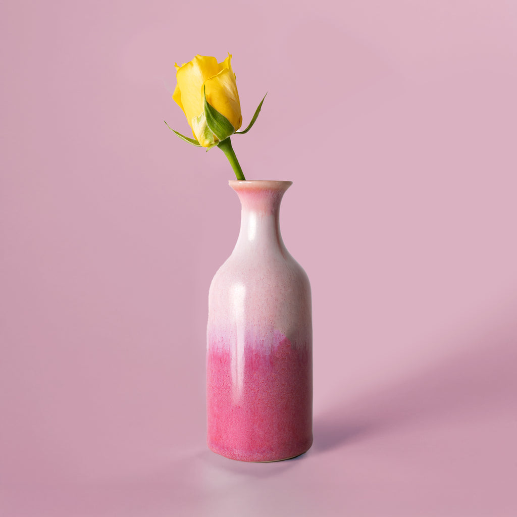 Small handmade flower vase from Pottery For The Planet in pink and white with a single yellow rose