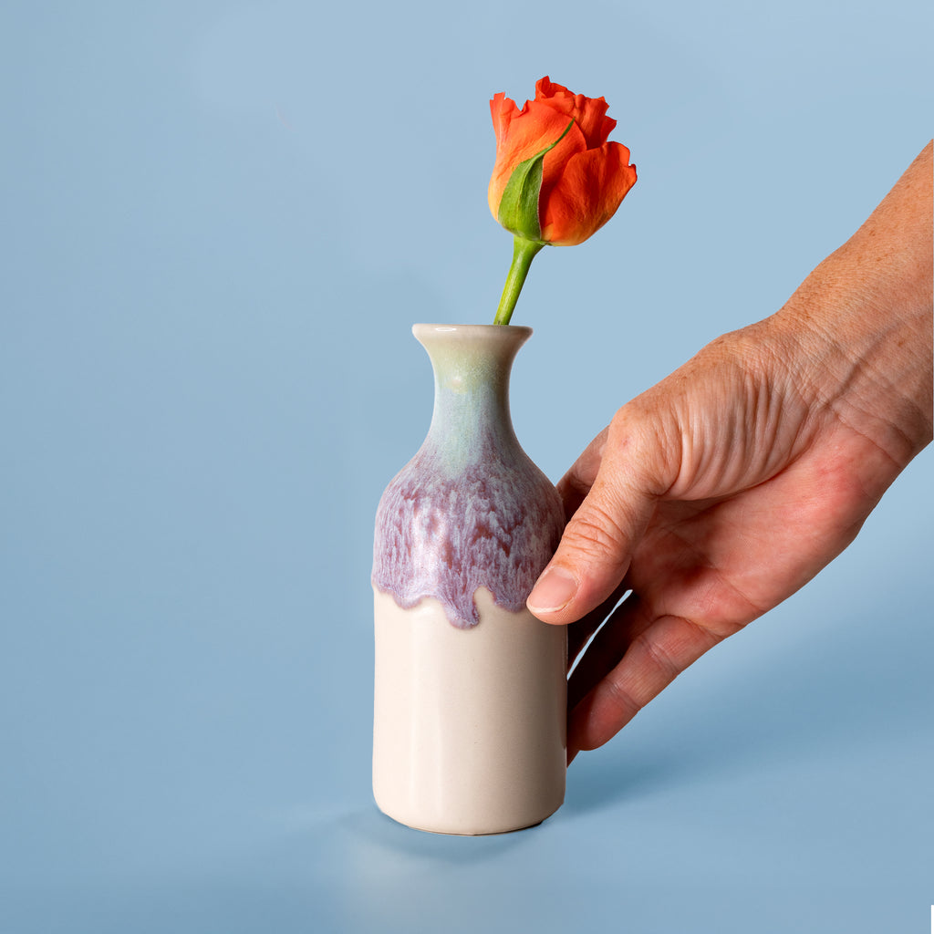 Pottery For The Planet small handmade flower vase with purple and beige glaze holding an orange rose