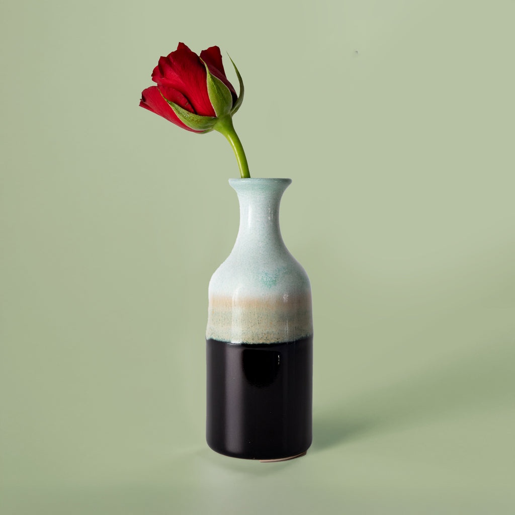 Pottery For The Planet small handmade flower vase with a red rose on light green background