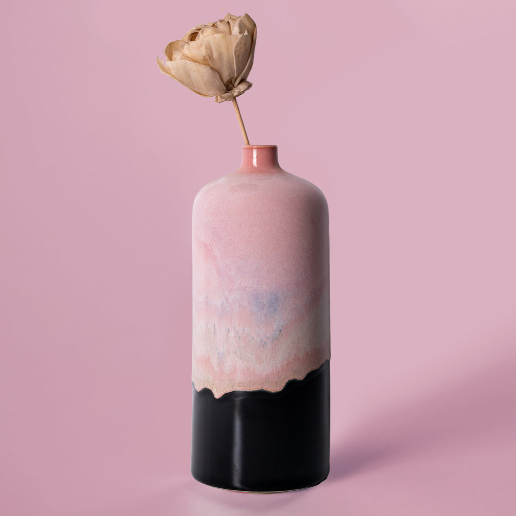 Pink and black ceramic medium decorative bud vase by Pottery For The Planet with a dried flower
