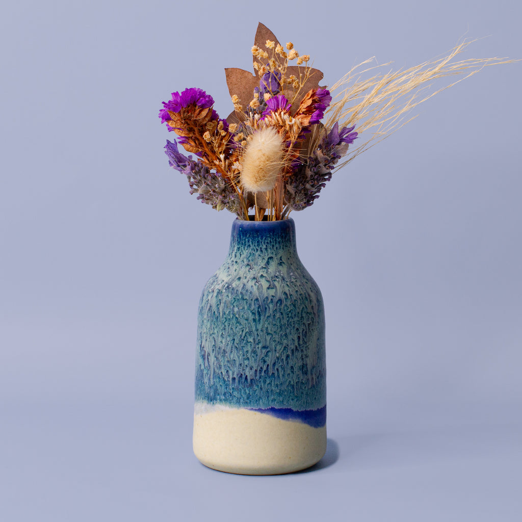 Pottery For The Planet modern decorative flower vase with blue glaze holding dried purple and brown flowers
