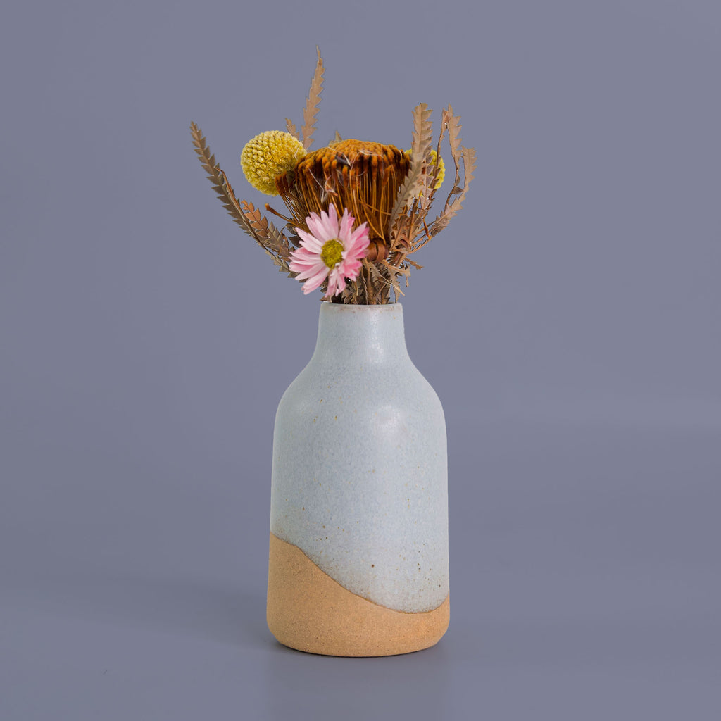 Modern decorative flower vase by Pottery For The Planet with two-tone ceramic and dried floral arrangement