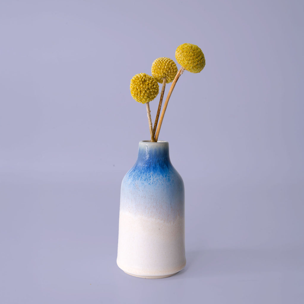 Pottery For The Planet modern decorative flower vase with blue and white gradient finish holding yellow billy balls