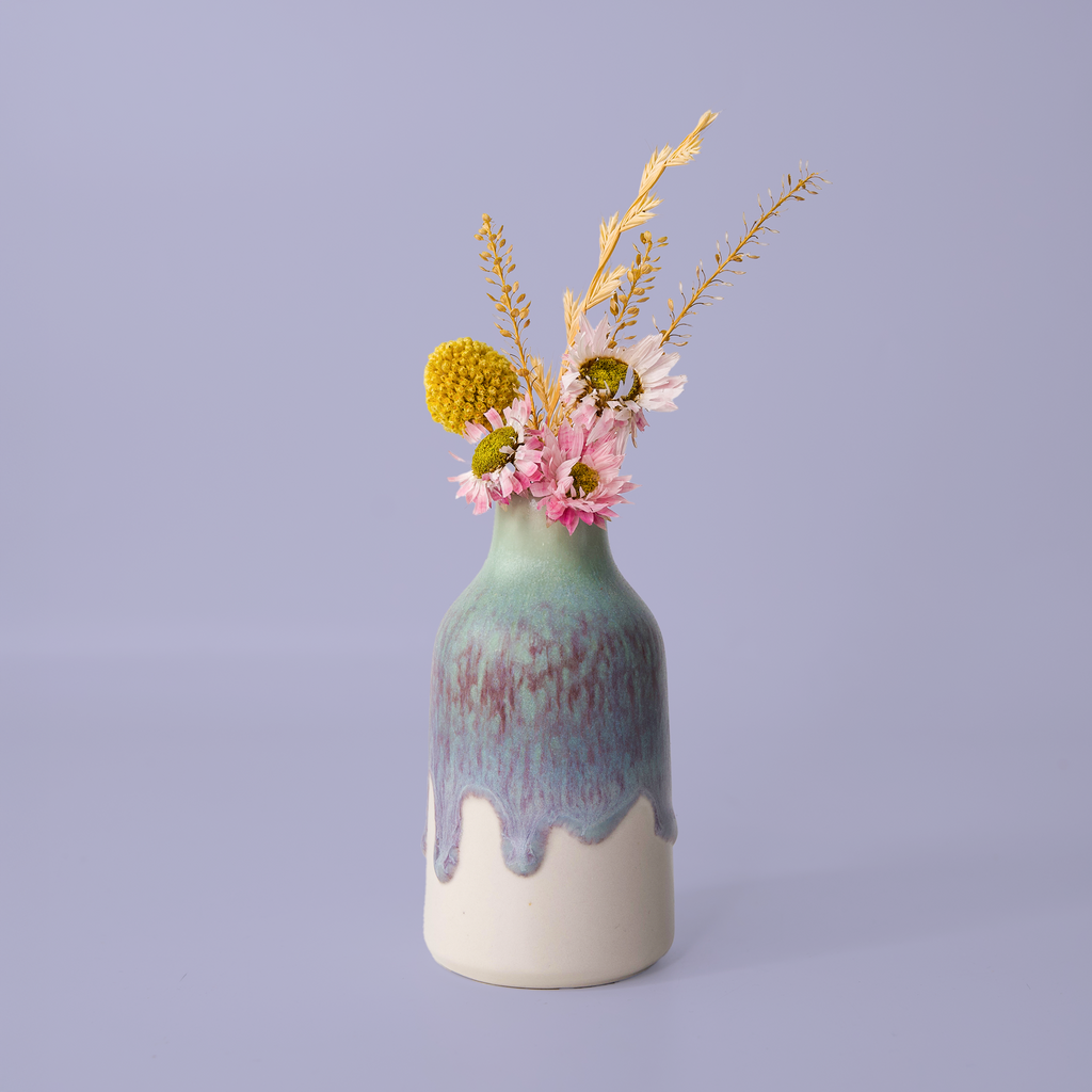Pottery For The Planet modern decorative flower vase with green and purple glaze holding pink and yellow flowers