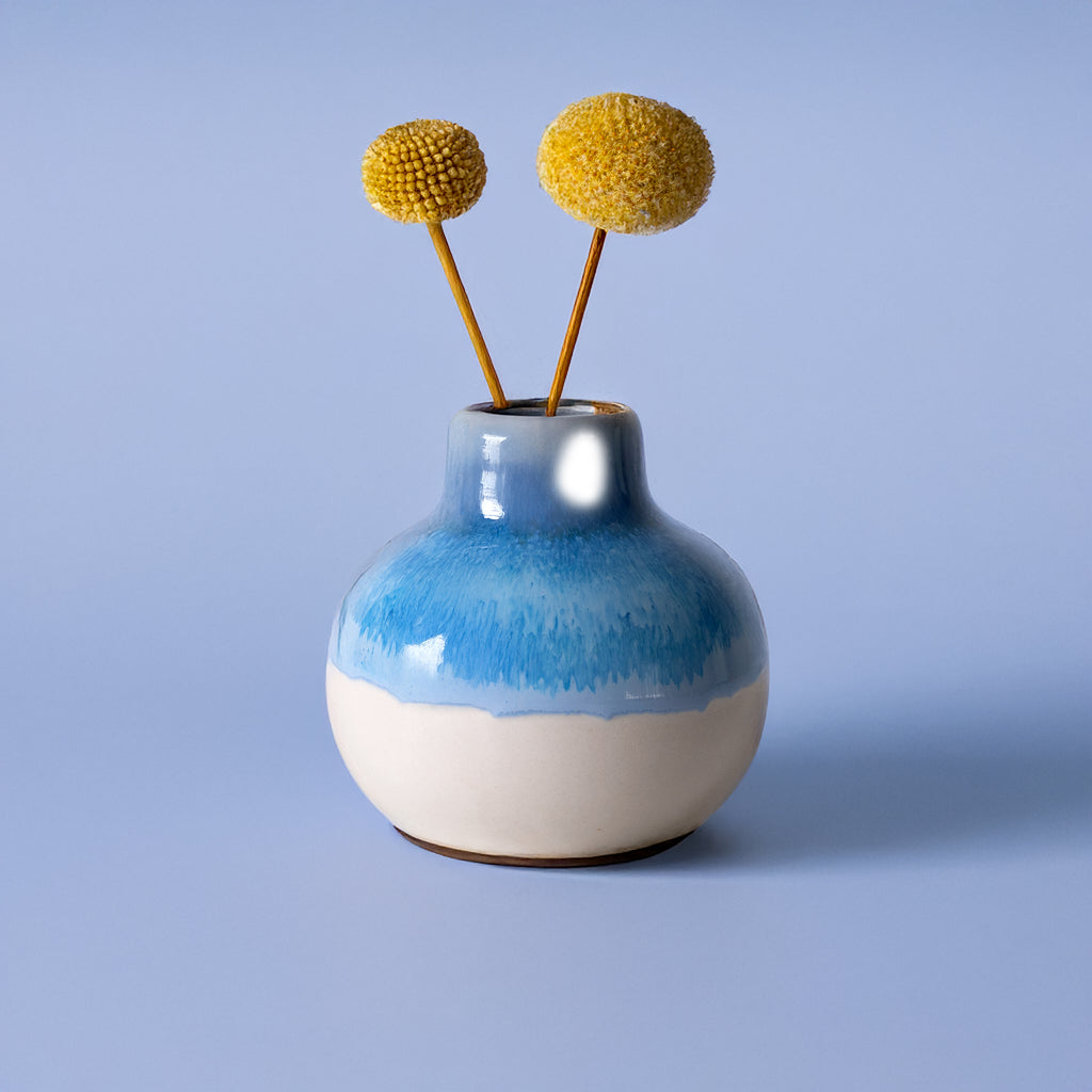 Small handmade home decor vase by Pottery For The Planet in blue and white with yellow dried flowers