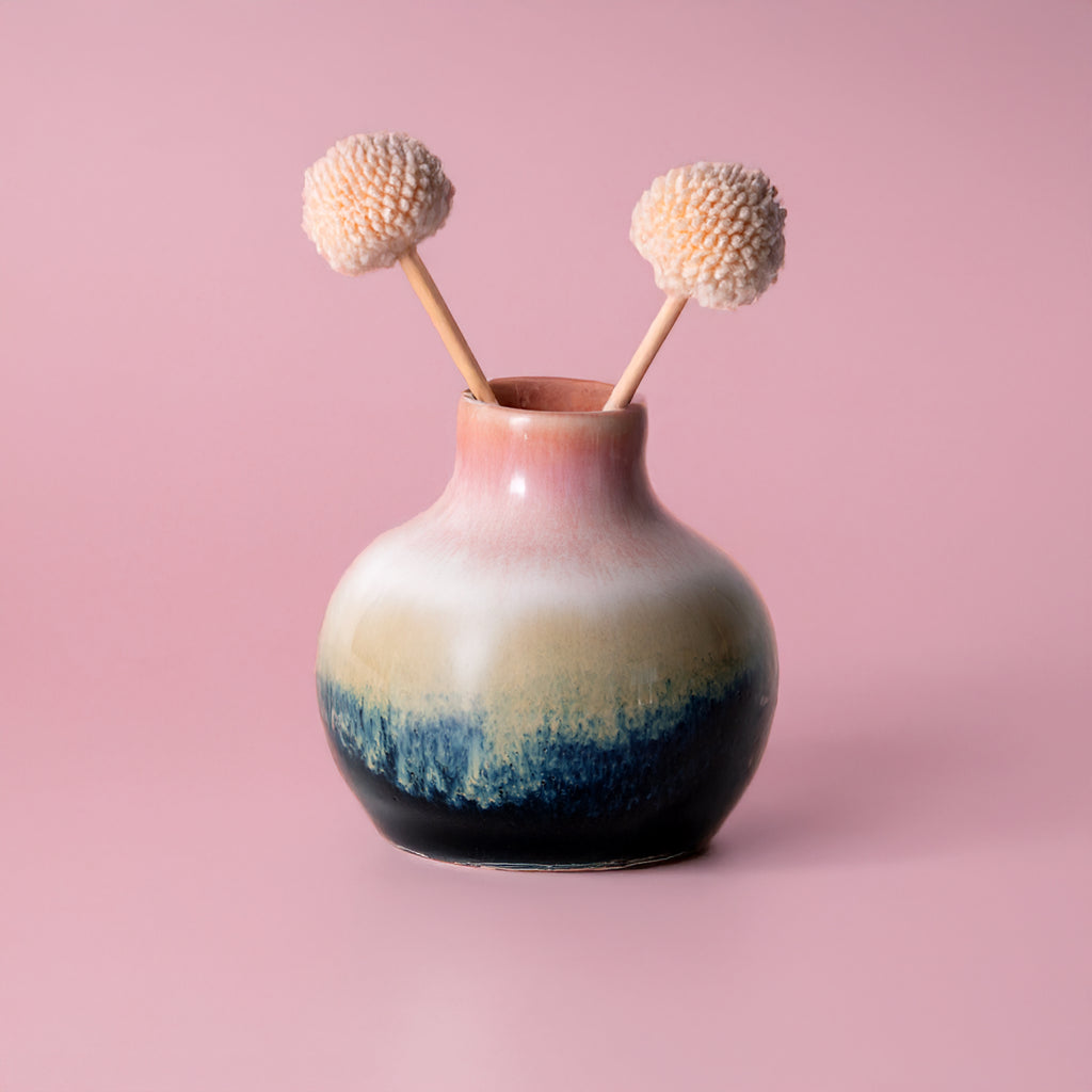 Small handmade home decor vase by Pottery For The Planet with gradient pink white blue glaze