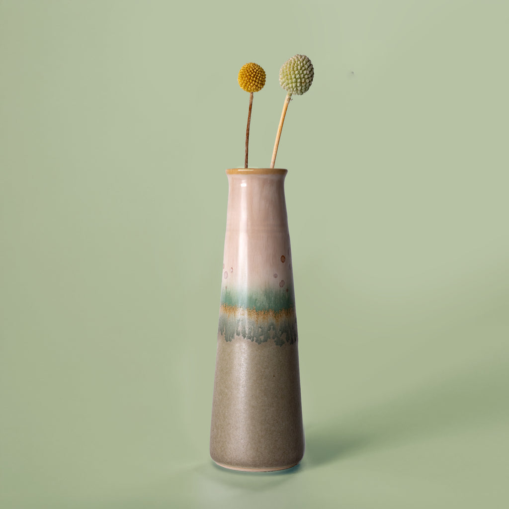 Pottery For The Planet ceramic sustainable home decor vase with green and beige glaze holding dried flowers