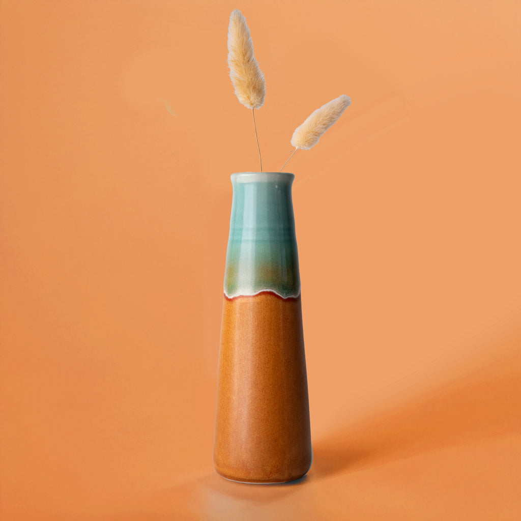 Pottery For The Planet tall ceramic sustainable home decor vase with teal and brown glaze holding dried pampas grass