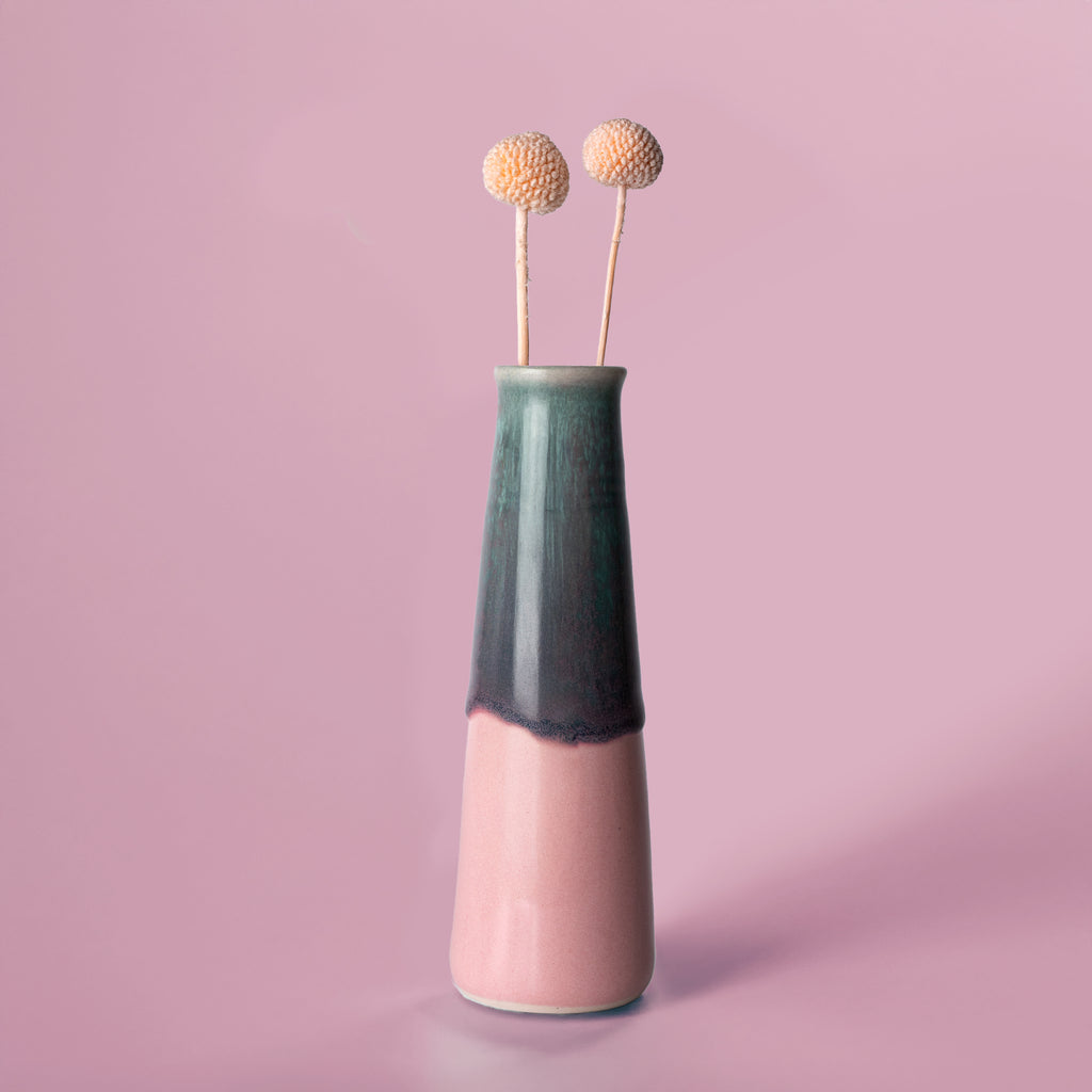 Pottery For The Planet sustainable home decor vase with green and pink glaze holding dried flowers