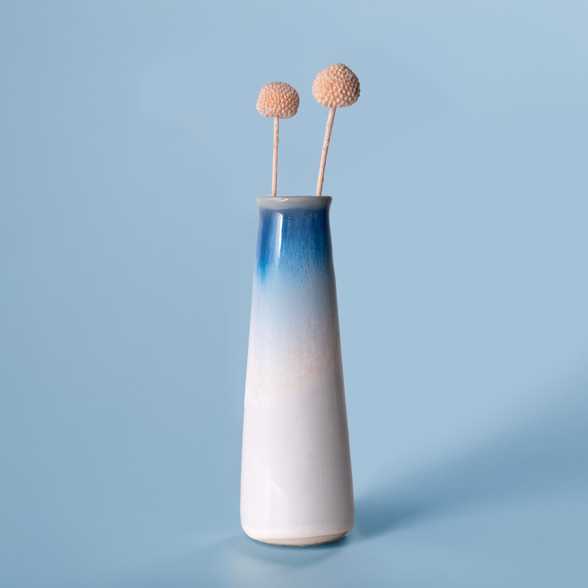 Pottery For The Planet blue and white gradient sustainable home decor vase with two dried flowers