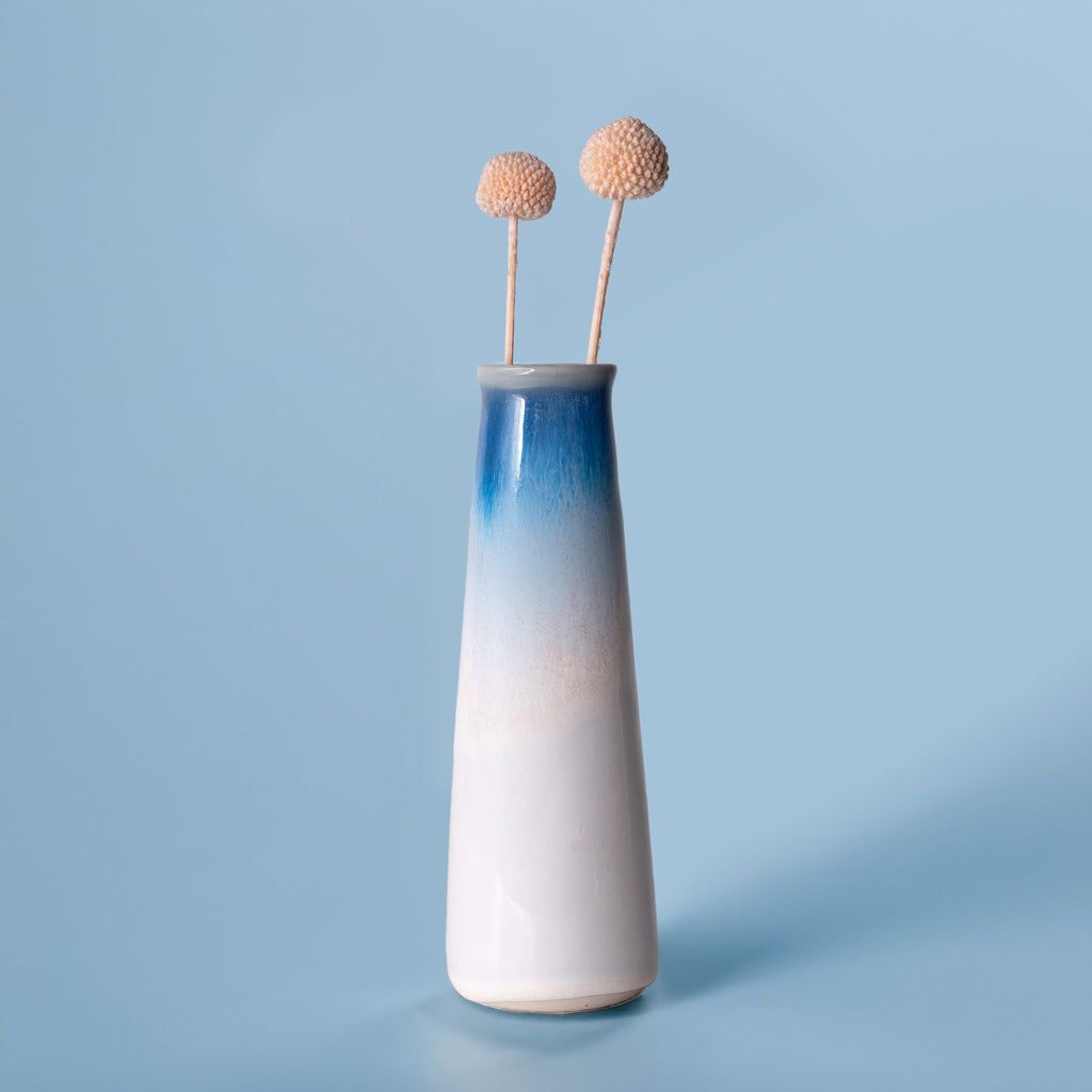 Pottery For The Planet blue and white gradient sustainable home decor vase with two dried flowers