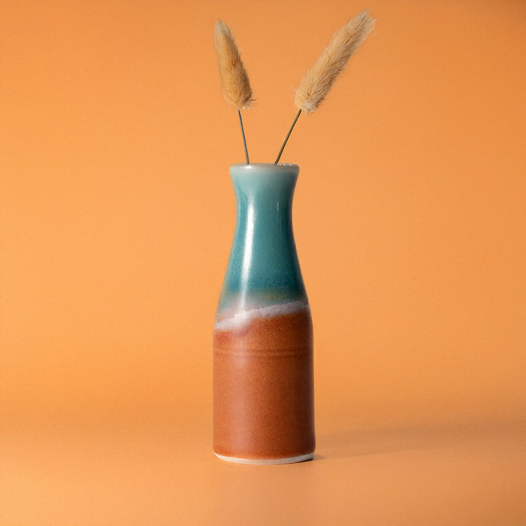 Pottery For The Planet unique ceramic flower vase with blue and brown gradient glaze holding dried flowers