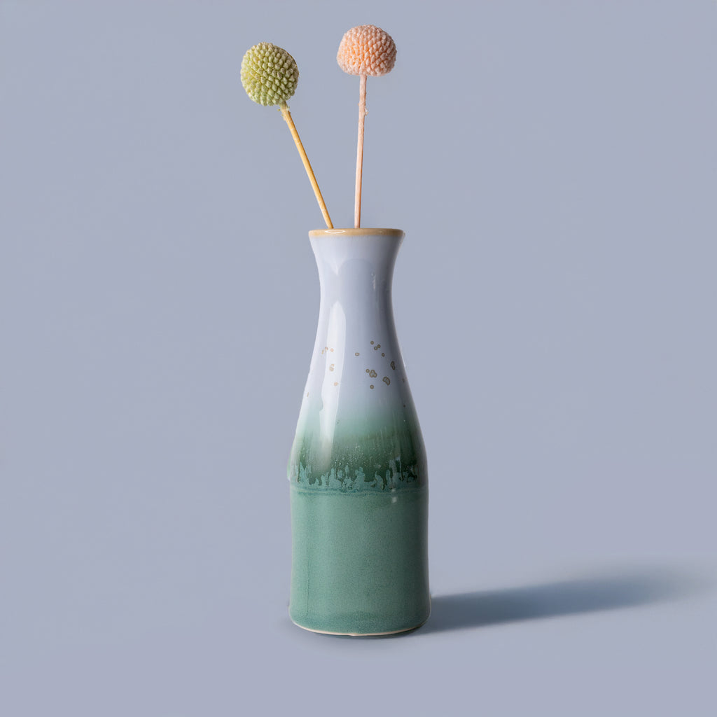 Pottery For The Planet unique ceramic flower vase with green and white glaze holding two decorative stems