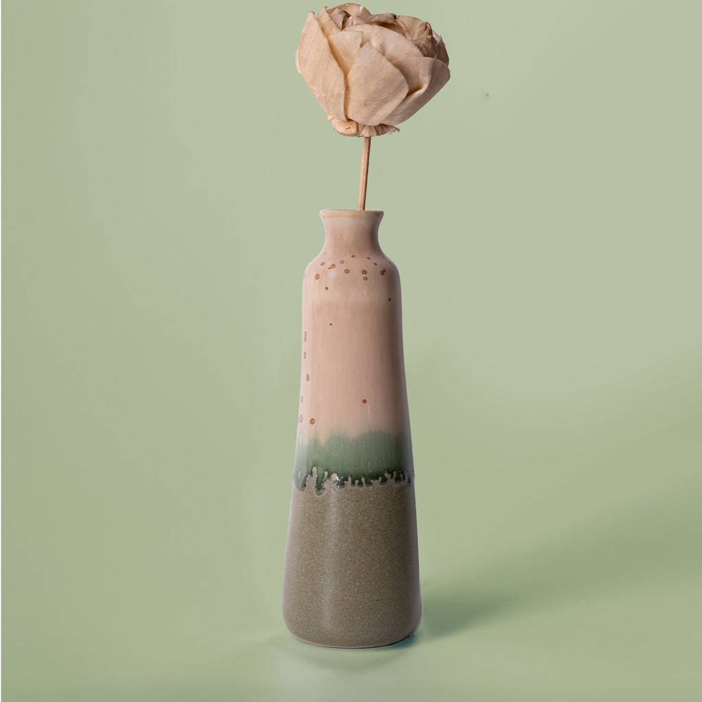 Unique handmade ceramic vase in pink and green glaze from Pottery For The Planet with dried flower