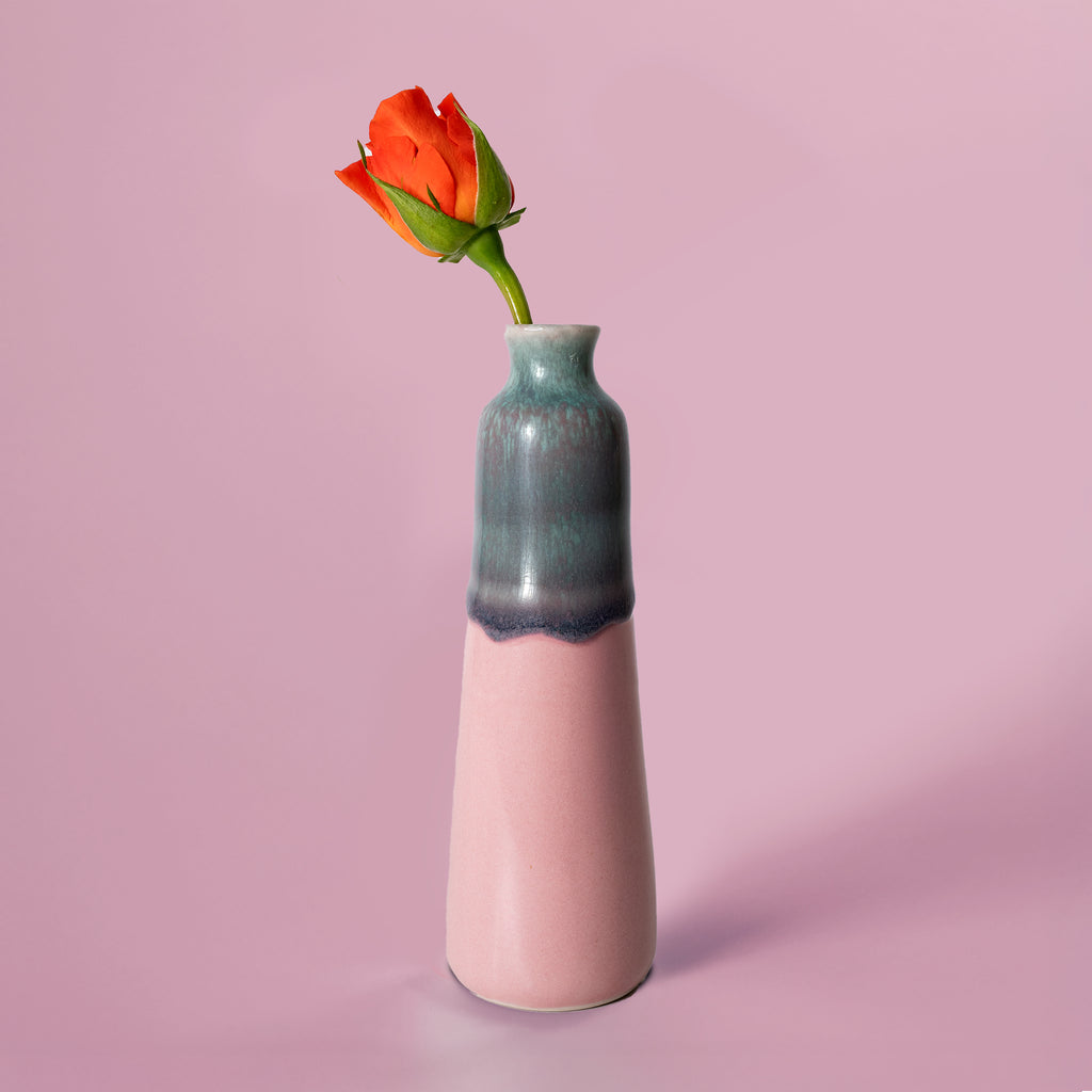 Unique handmade ceramic vase in pink and teal with a single orange rose from Pottery For The Planet