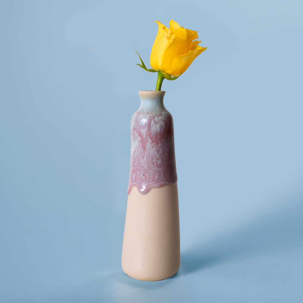 Unique handmade ceramic vase with purple and beige glaze holding a yellow rose flower