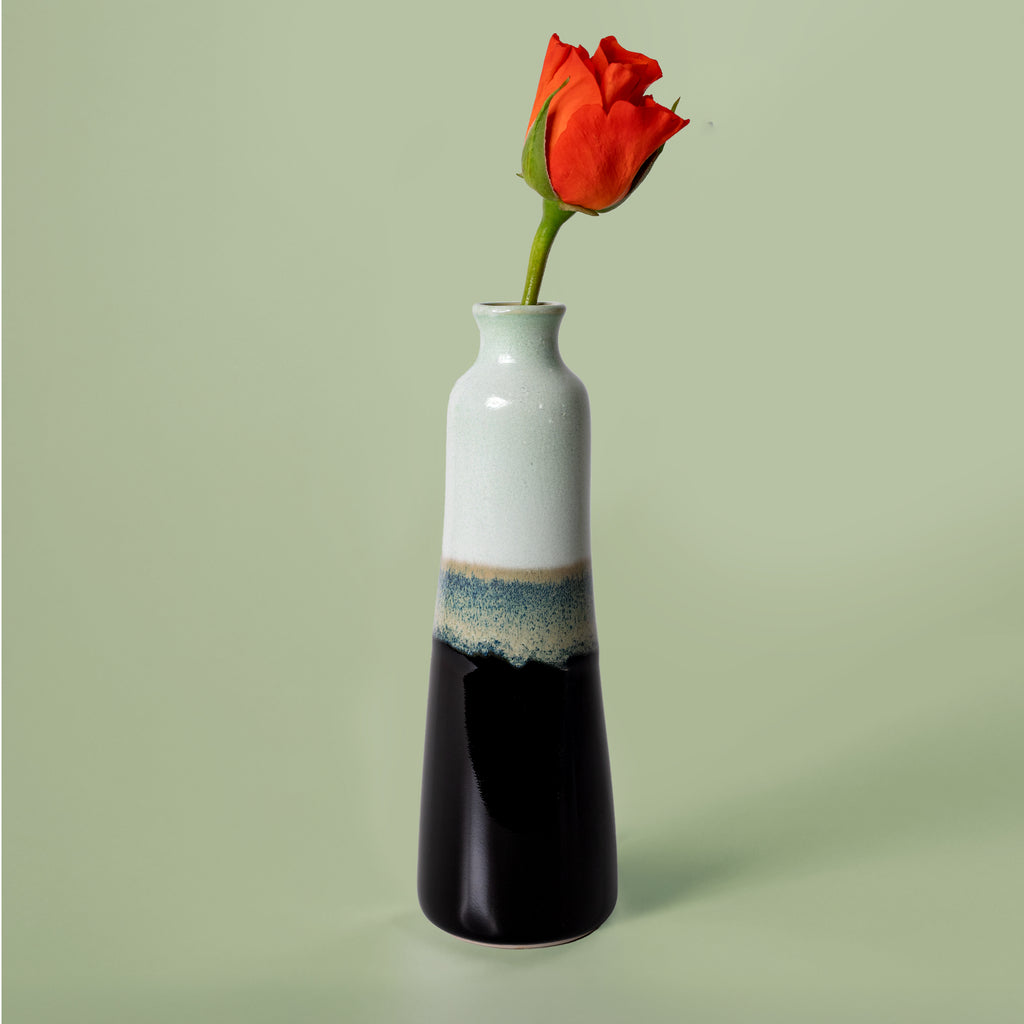 Unique handmade ceramic vase by Pottery For The Planet with a slender shape and a red flower