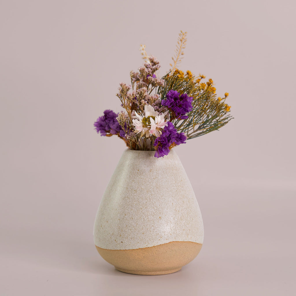 Unique pottery flower vase by Pottery For The Planet with a natural two-tone finish holding dried flowers