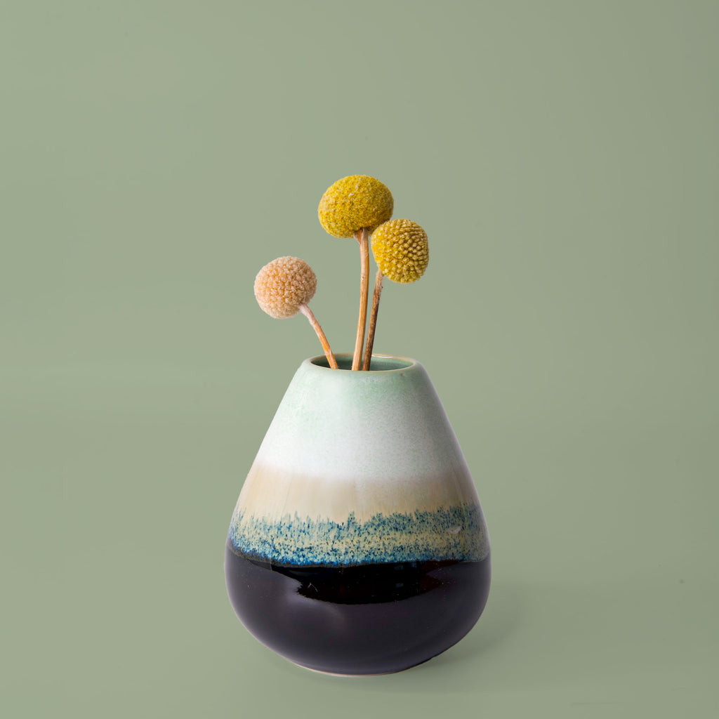 Unique pottery flower vase from Pottery For The Planet in gradient green and blue with dried yellow and peach flowers