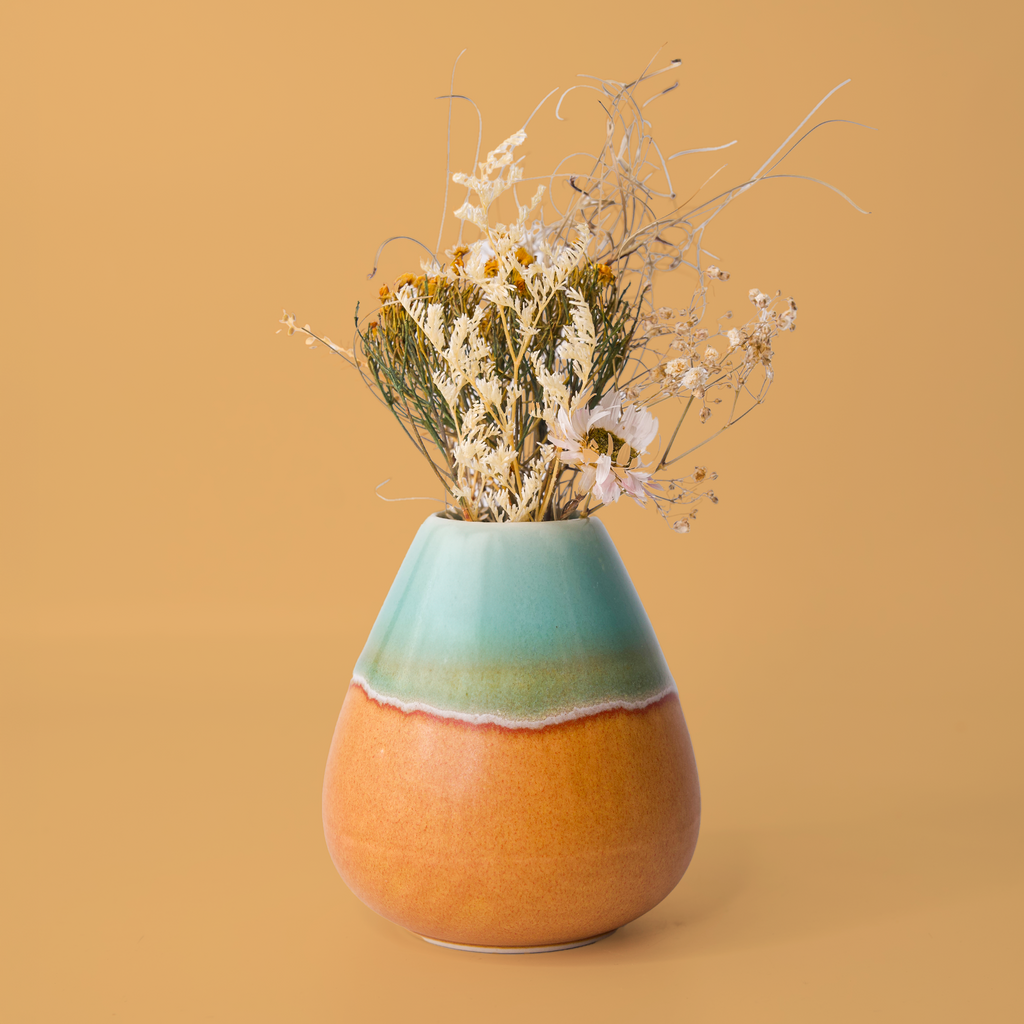 Unique pottery flower vase by Pottery For The Planet in teal and orange with dried floral arrangement