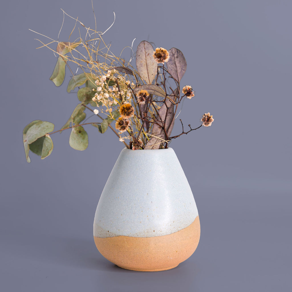 Unique pottery flower vase by Pottery For The Planet with a two-tone design holding dried flowers