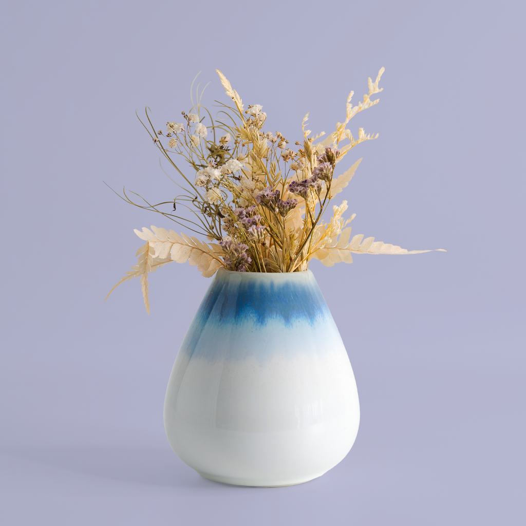 Unique pottery flower vase by Pottery For The Planet with blue gradient and dried floral arrangement