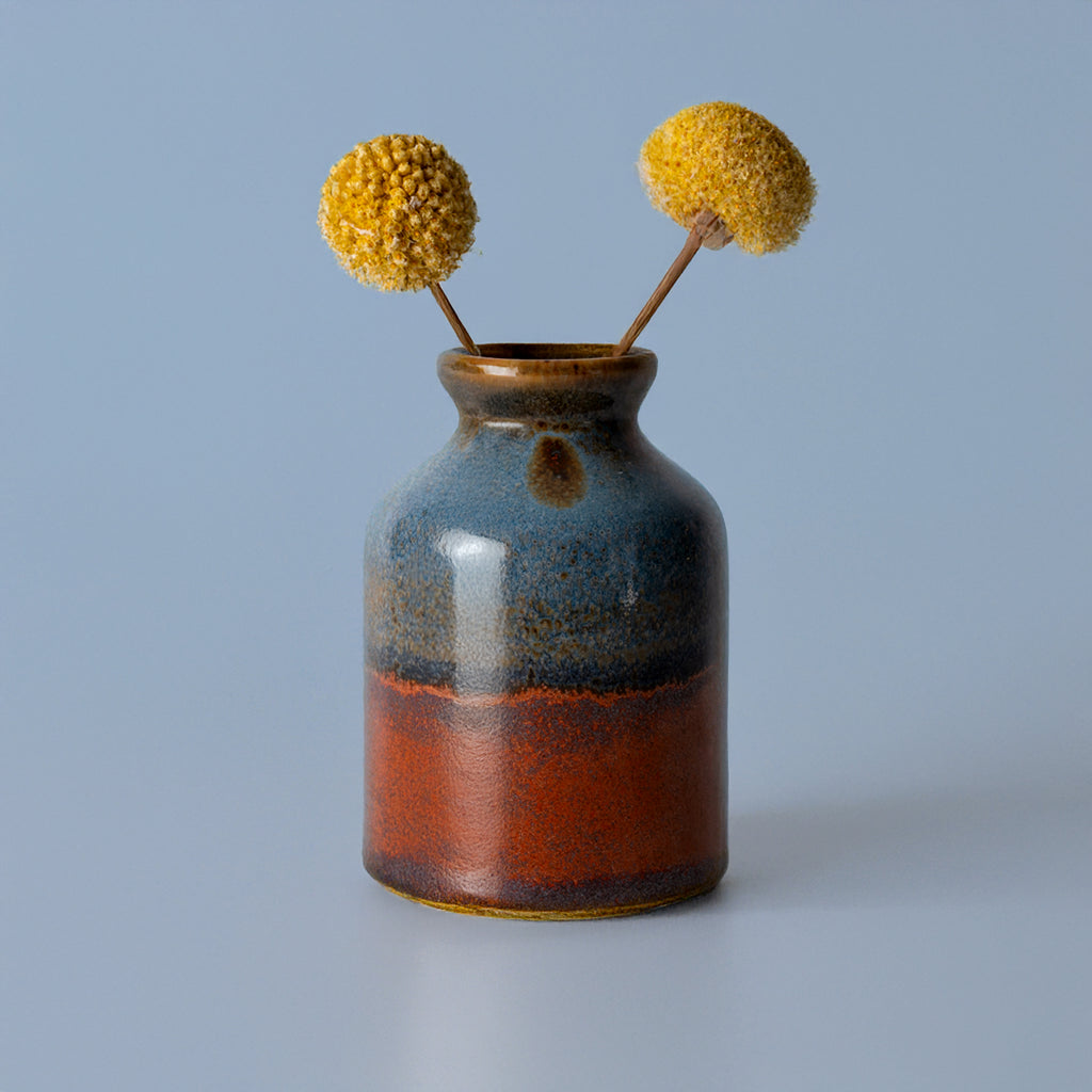 Pottery For The Planet miniature decorative vase for shelf with blue and brown glaze holding yellow dried flowers