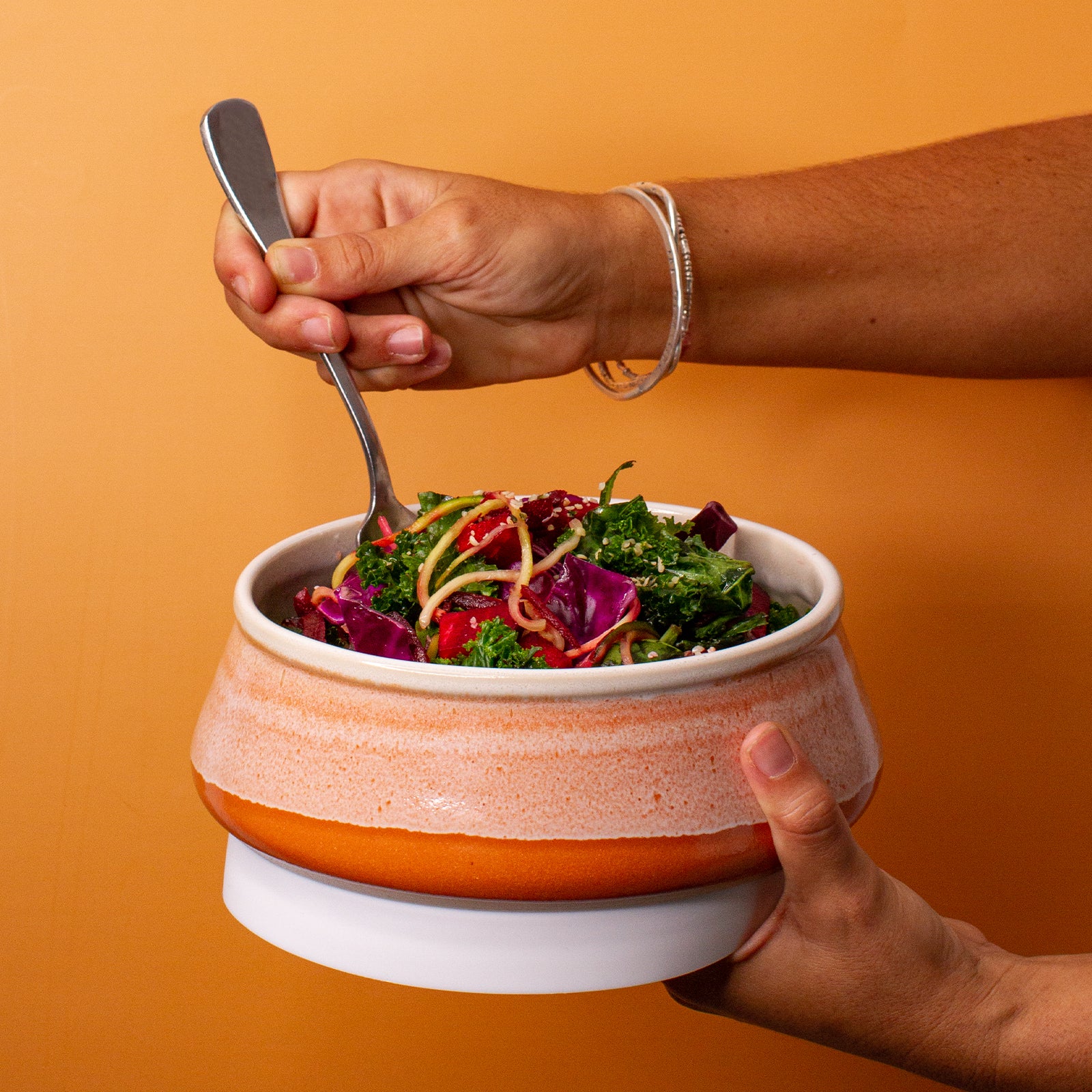 Orange Ceramic Travel Bowl in hand