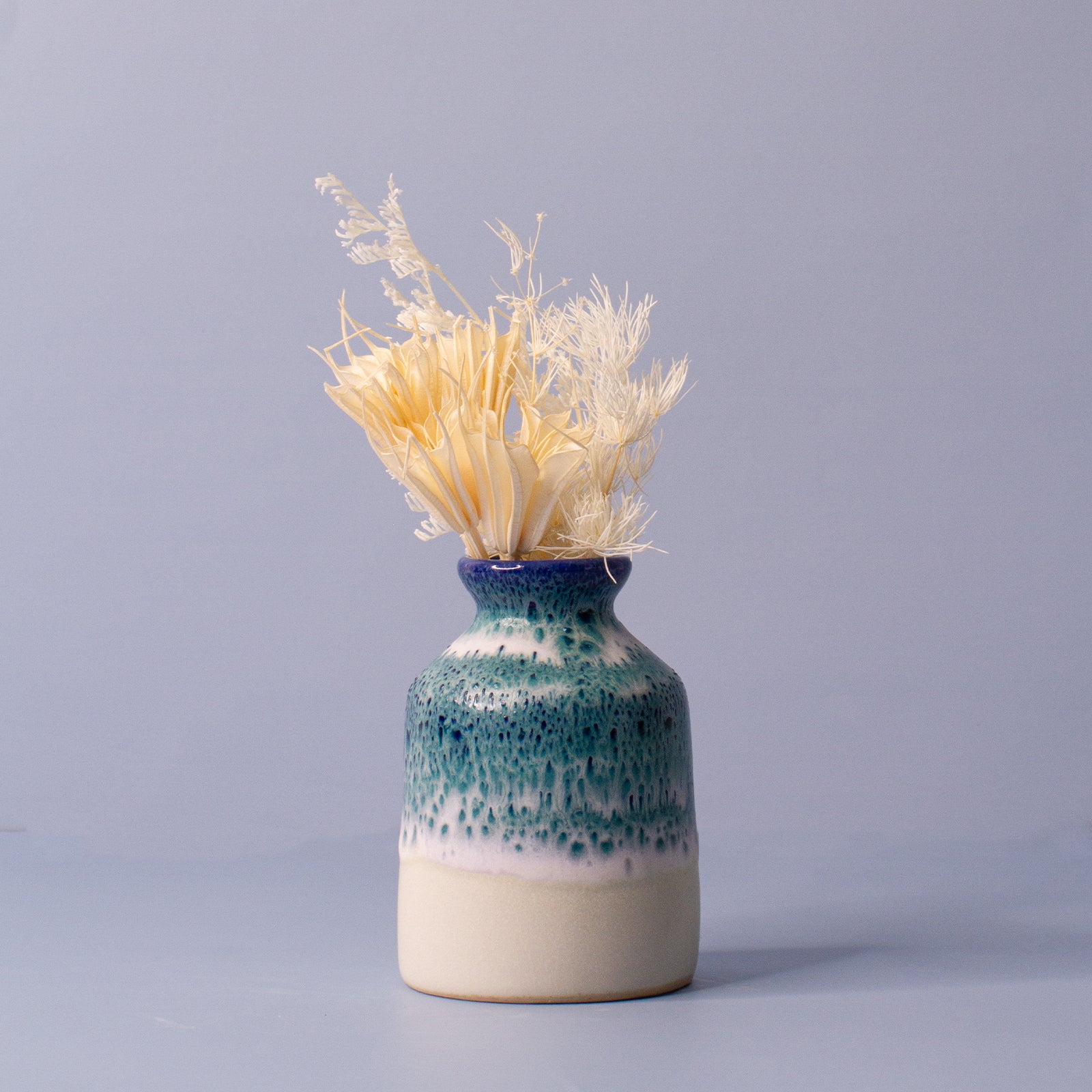 Pottery For The Planet miniature decorative vase for shelf with blue and white glaze holding dried flowers